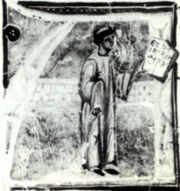 Huc Brunets, como l se llama en el manuscrito, se representa como un tonsured clrigo y hombre de letras.